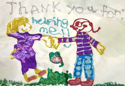 Child's drawing of two figures and the words Thank you for helping me.