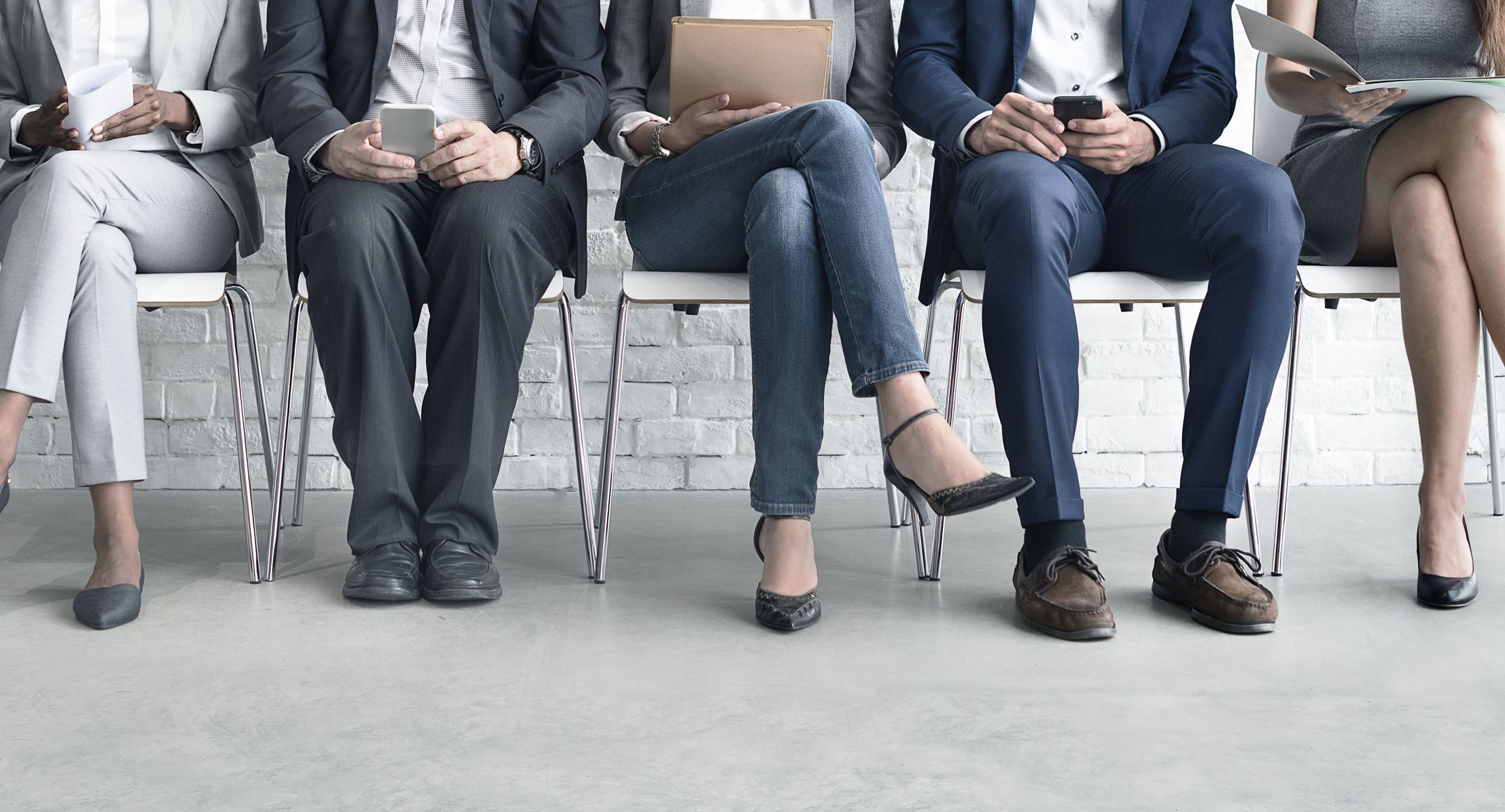 Image of several people seated in a waiting room.